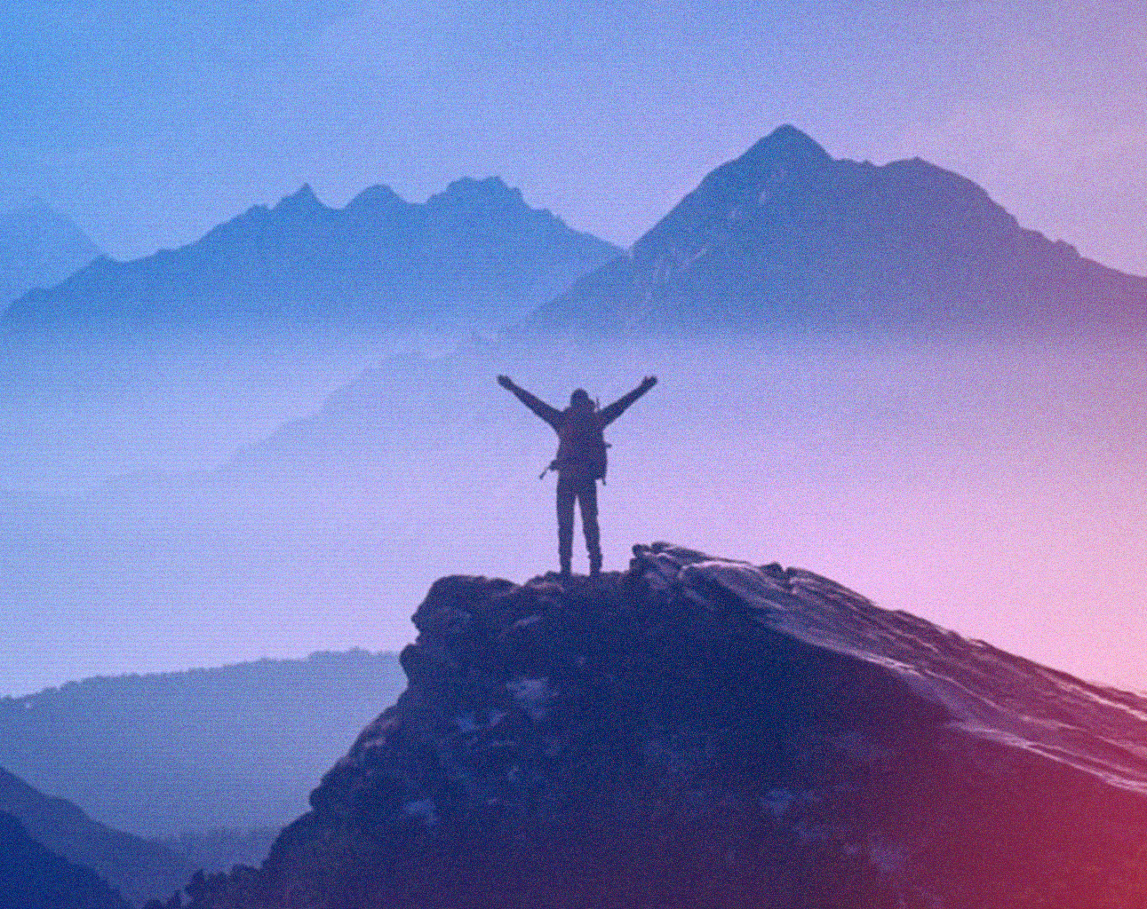 Man at the top of a mountain
